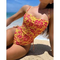 High-quality yellow and pink floral swimsuit for women, perfect for beach or poolside wear. Comfortable fit with adjustable straps, ideal for summer vacations and seaside lounging.
