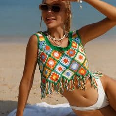 Stylish crochet tank top with vibrant, multicolored granny squares, fringed hem, perfect for beachwear, summer outfits, and casual seaside style.