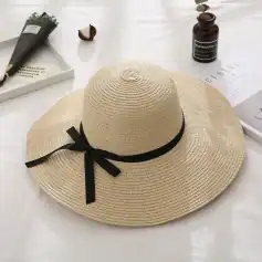 Stylish woven straw sun hat with black ribbon, perfect for summer outdoor activities and vacation. Breathable design offers sun protection and elegant look.