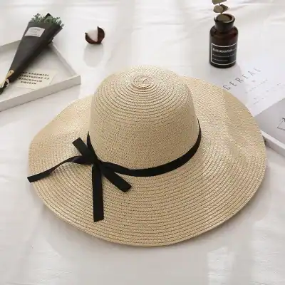 Stylish woven straw sun hat with black ribbon, perfect for summer outdoor activities and vacation. Breathable design offers sun protection and elegant look.
