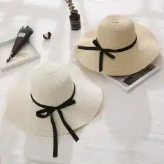Stylish woven sun hats with black satin ribbons, perfect for summer sun protection and fashion. Ideal accessories for beach outings, vacations, or casual outdoor events.