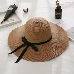 Stylish wide-brim straw hat with black ribbon, perfect for sun protection and beach outings. Made from high-quality woven material for comfort and durability.