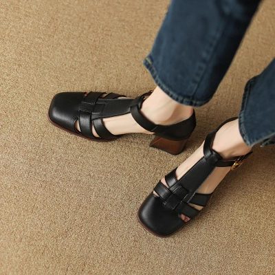 Elegant black leather sandals with open toes, ankle straps, and a sturdy block heel, perfect for fashionable women seeking comfort and style.