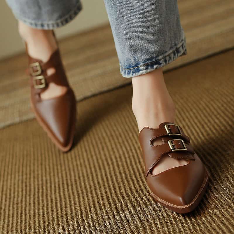 Comfortable brown leather shoes with double buckle accents, perfect for casual or professional wear.