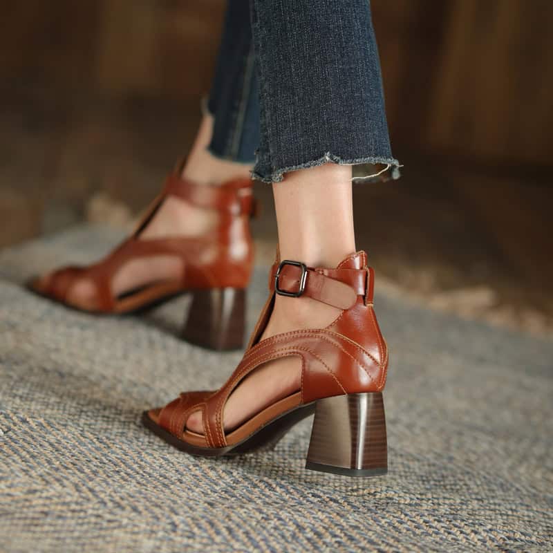 High-quality brown leather open-toe ankle heels with chunky heel and ankle strap, perfect for fashionable women.