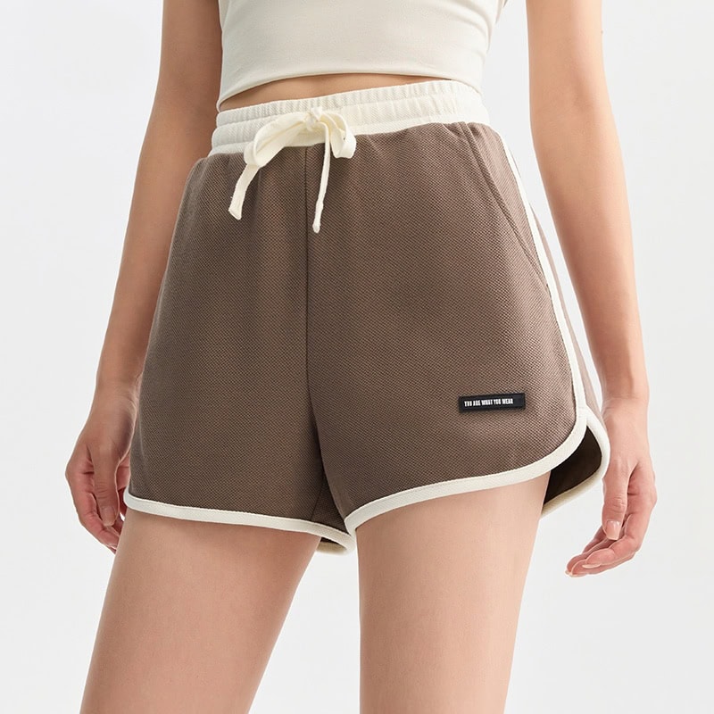 Soft brown women's casual lounge shorts with white trim, adjustable drawstring, and breathable fabric. Perfect for relaxed, stylish homewear or leisure activities.