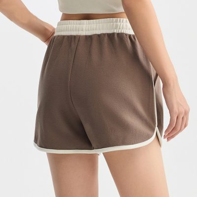 Comfortable brown sports shorts with white trim, perfect for casual wear, workouts, or lounging. Made from lightweight, breathable fabric for active lifestyles.
