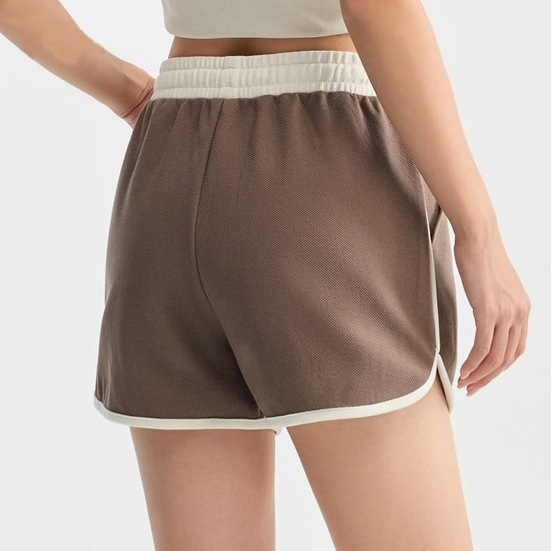 Comfortable brown sports shorts with white trim, perfect for casual wear, workouts, or lounging. Made from lightweight, breathable fabric for active lifestyles.