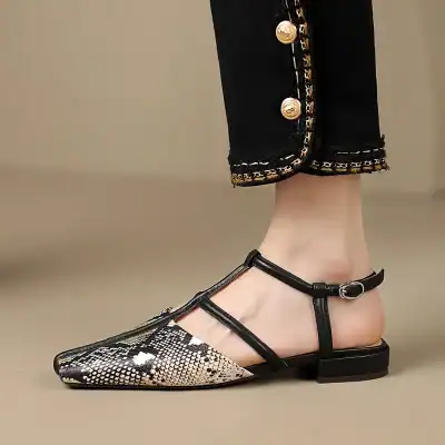 High-quality women's snake print flat shoe with pointed toe and ankle strap, perfect for stylish comfort and versatile fashion looks.