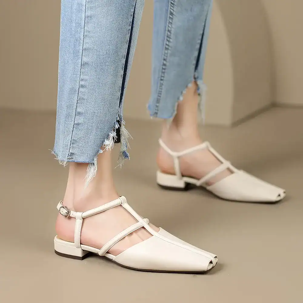 Stylish women's pointed toe sandals showcased in neutral beige, featuring slim ankle straps with buckle closures, perfect for fashionable summer wear.