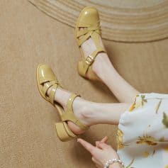 Stylish yellow open-toe sandals with ankle straps and block heels, perfect for fashionable casual or semi-formal outfits. Comfortable and trendy footwear for women.