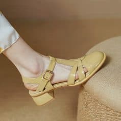 Stylish yellow women's sandal with ankle strap and buckle closure, perfect for elegant summer looks and comfortable wear.