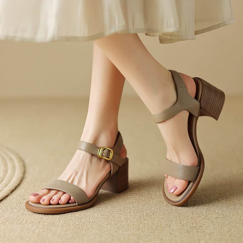 Stylish beige women’s high-heeled sandals with ankle strap, perfect for summer outfits and formal occasions. Comfortable block heel design enhances style and stability.
