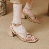 Elegant beige women's heeled sandals for summer, featuring ankle straps and block heels. Perfect for stylish outings and occasions.