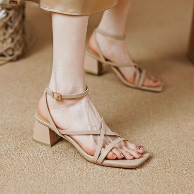Elegant beige women's heeled sandals for summer, featuring ankle straps and block heels. Perfect for stylish outings and occasions.