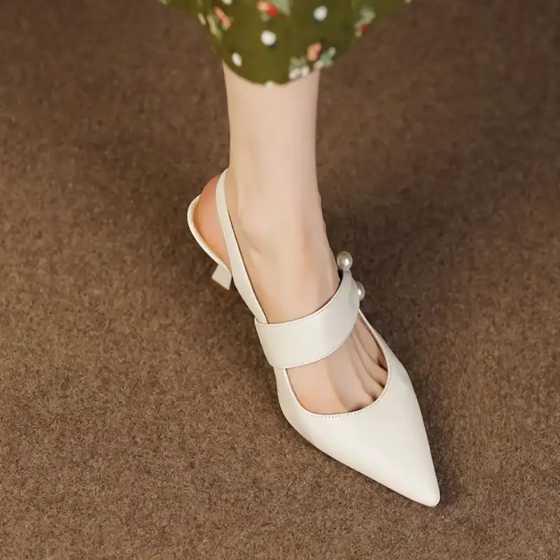 High-quality white women's shoe featuring a pointed toe and pearl embellishments, perfect for stylish occasions and enhancing your footwear collection.