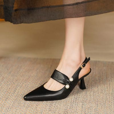 Stylish black women's high-heel shoes with pearl accents, pointed toe, and slingback strap, perfect for formal occasions and fashionable office wear.