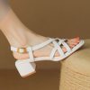 Elegant white women's sandals with block heel, ankle buckle strap, perfect for casual and dressy occasions, offering comfort and style.