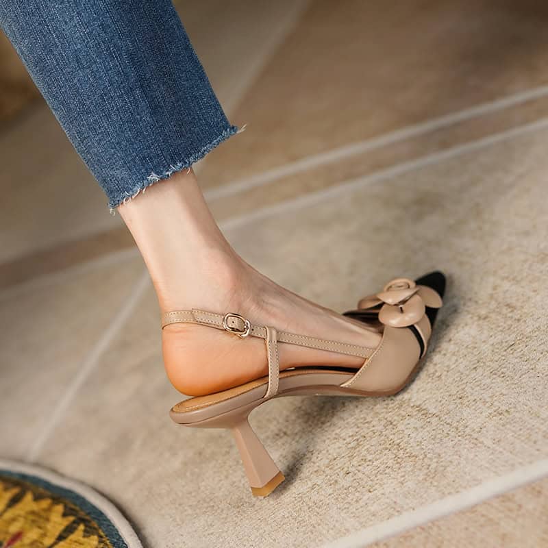Stylish nude high heel shoe with a delicate bow, perfect for formal occasions or stylish outfits. Features comfortable ankle strap and chic design for women’s footwear needs.
