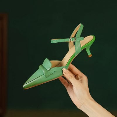 Stylish green women's high heel shoe with pointed toe, ankle strap, and chic design, perfect for fashionable events and everyday wear.