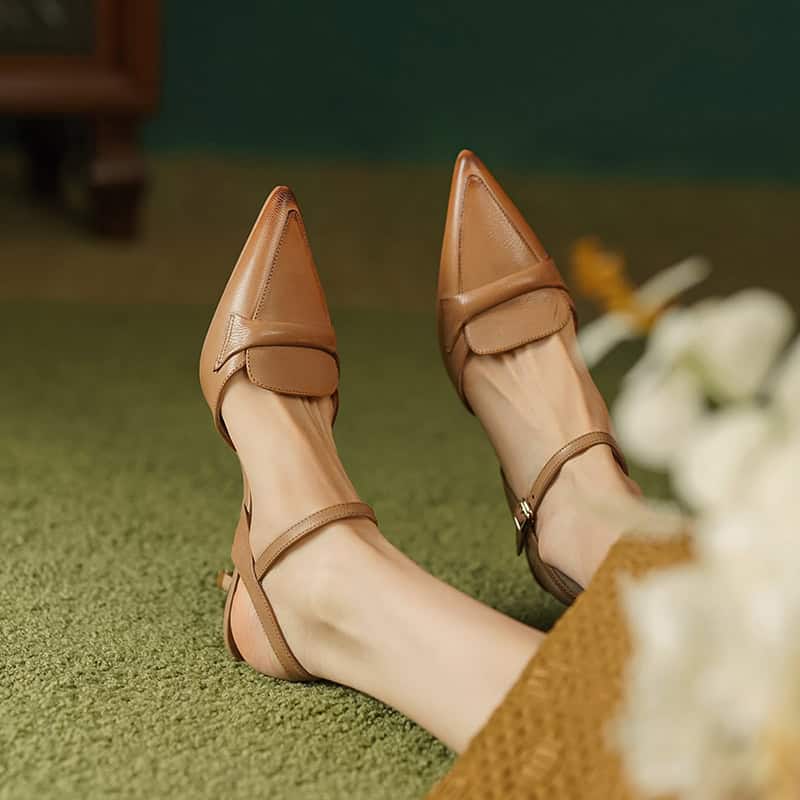 Elegant brown pointed-toe ankle strap heels perfect for fashion-forward women.