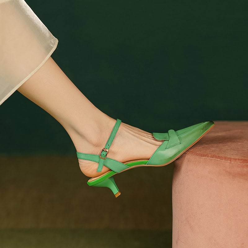 Elegant green women's shoe with a kitten heel and ankle strap, perfect for fashion-forward looks and special occasions.