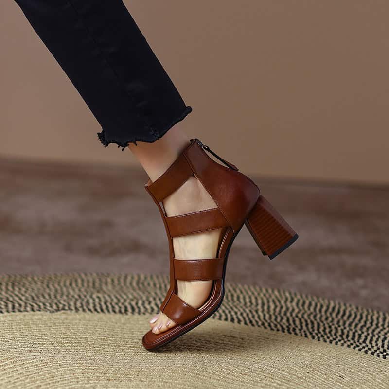 Elegant brown leather block heel sandal on a model's foot, perfect for stylish footwear and trendy accessories.
