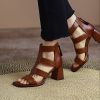 Elegant brown open-toe high-heel sandals with multiple straps, perfect for fashionable women seeking comfort and style in their footwear.
