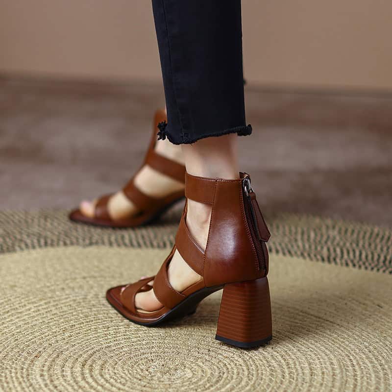 Elegant brown leather sandal with ankle strap and side zipper, perfect for fashionable women seeking comfort and style in every step.