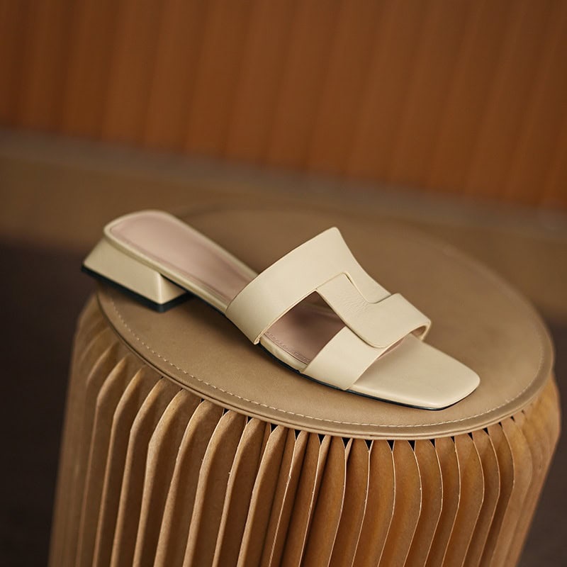 Comfortable beige slip-on sandals with stylish wide strap, perfect for casual and fashion-forward looks. Ideal footwear for everyday wear and outdoor activities.