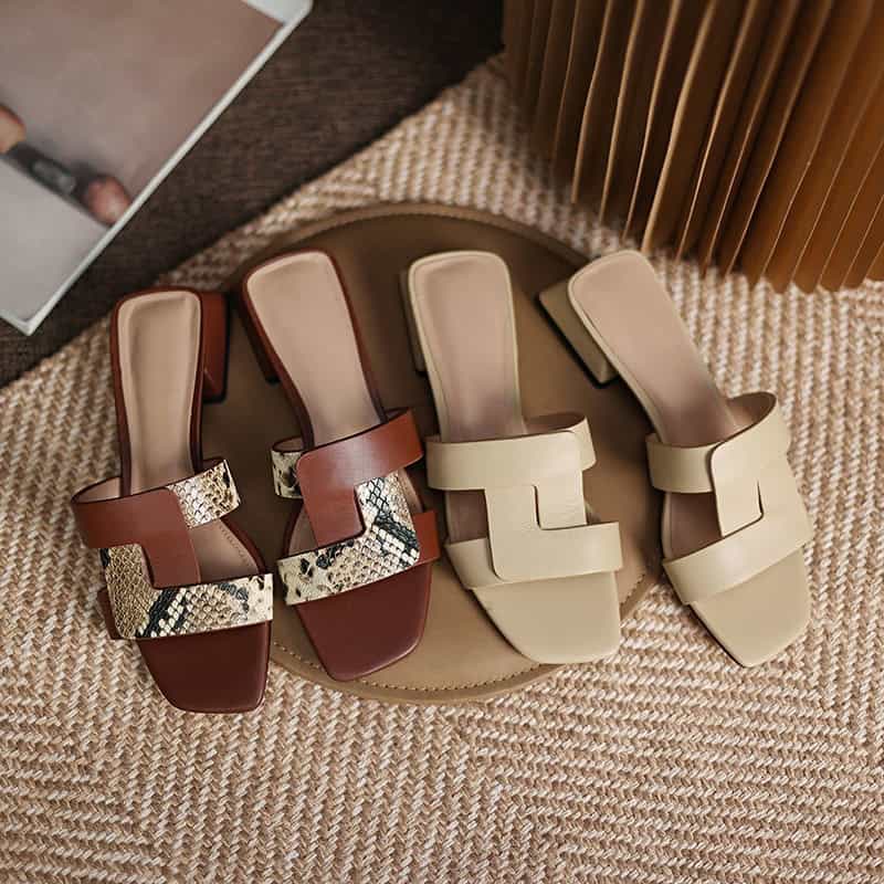 Elegant women's flat sandals featuring snake print leather straps and comfortable footbed, perfect for stylish summer outfits and casual wear.