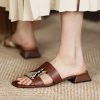 Stylish brown leather sandals with a snake-print strap, perfect for women seeking fashionable comfort for everyday wear or special occasions.