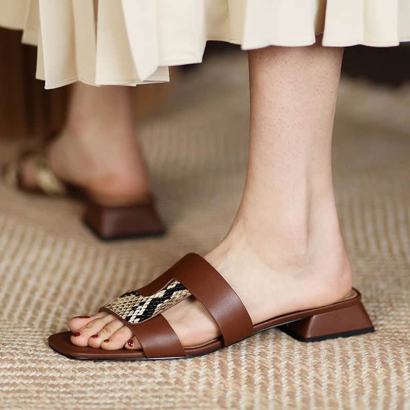 Stylish brown leather sandals with a snake-print strap, perfect for women seeking fashionable comfort for everyday wear or special occasions.