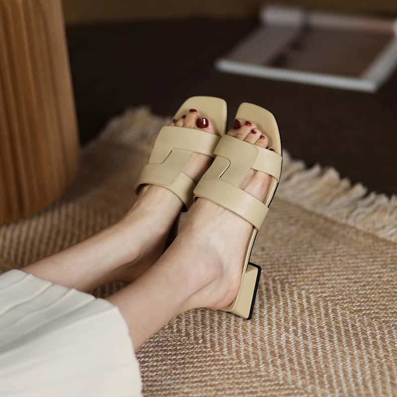 Nude heeled sandals featuring wide straps and open toes, perfect for stylish looks. Comfortable and trendy footwear for women, ideal for casual or dressy occasions.