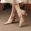 Stylish nude women's high heels with pointed toe, ankle strap, and high heel, perfect for fashion-forward footwear and comfortable yet chic shoe options.
