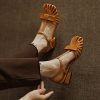 Stylish brown sandals with a strappy design, featuring a block heel perfect for casual and semi-formal occasions. Comfy and trendy footwear for fashion-forward individuals.