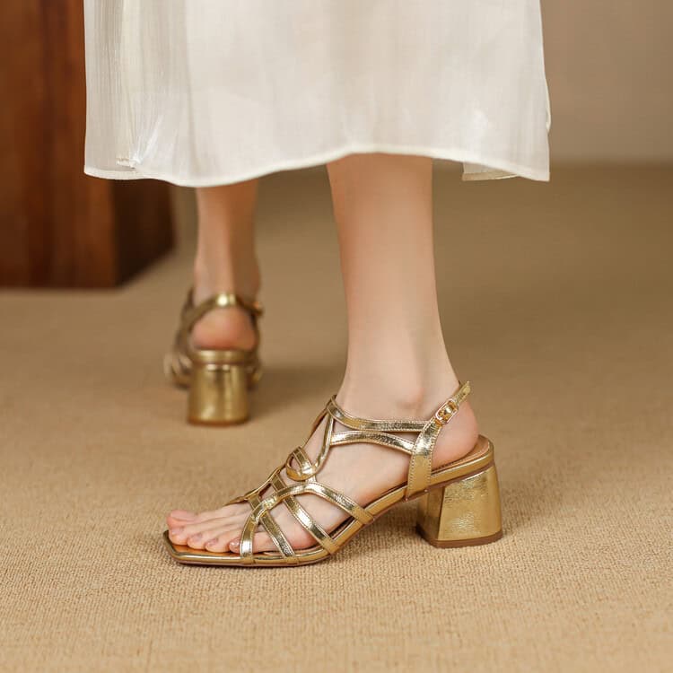 Gold women's high-heeled sandals, open-toe design, fashionable footwear, suitable for formal or stylish events.
