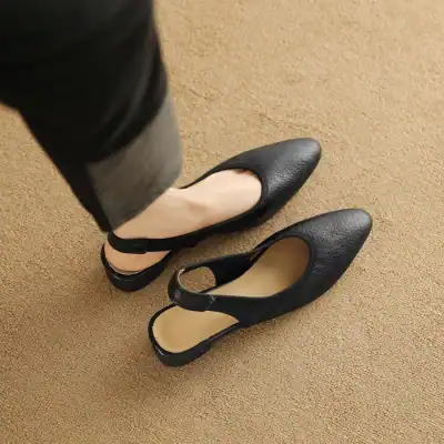 Close-up of stylish black leather women's shoes with a T-strap design, perfect for office or casual wear, showcasing comfort and sophisticated style.