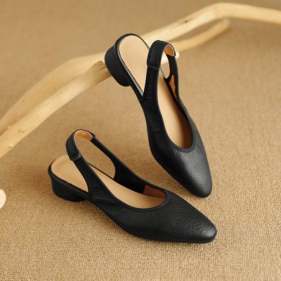 Stylish black slip-on shoes with a comfortable low heel and durable leather upper, perfect for everyday wear or office attire.