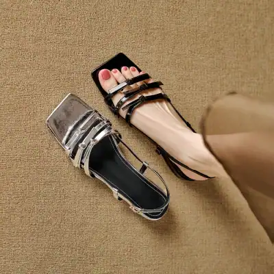 Elevate your style with trendy black and silver sandals featuring unique transparent straps, perfect for fashionable women seeking comfort and elegance.