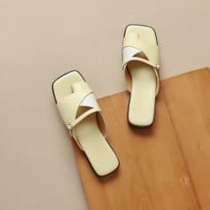 Comfortable beige women's slip-on sandals with crisscross straps, ideal for casual or summer wear, featuring a cushioned insole and trendy minimalist design.