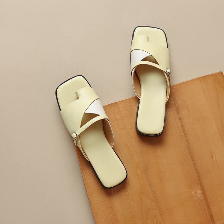Comfortable beige women's slip-on sandals with crisscross straps, ideal for casual or summer wear, featuring a cushioned insole and trendy minimalist design.