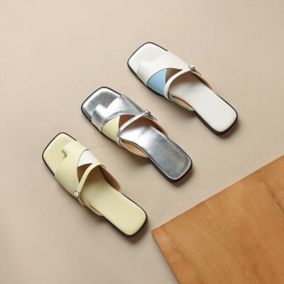 Elegant women's slides with colorful straps and comfortable flat soles, perfect for casual and trendy summer footwear.