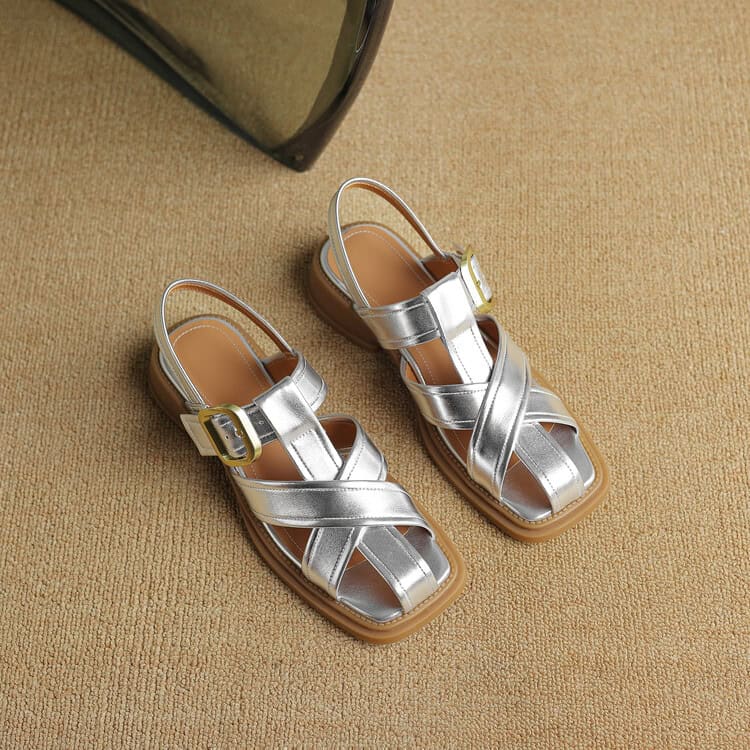 A pair of trendy silver children's sandals with buckle straps, perfect for summer and casual wear. Comfortable and fashionable footwear for kids, available at Monalisa Store.