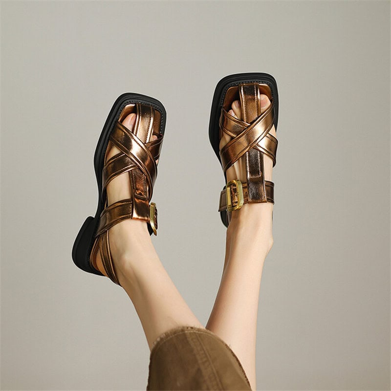 Stylish metallic bronze sandals featuring adjustable straps and buckles for a perfect fit, ideal for casual or dressy occasions.