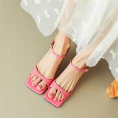 Elegant pink high-heel sandals with ankle straps, perfect for fashionable women. Comfortable, trendy, ideal for dressing up or casual outings. Enhance your style with these chic footwear options.