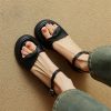 Fashionable black sandals with ankle straps, comfortable and trendy footwear, perfect for casual wear and summer outfits.