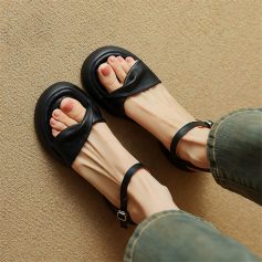 Fashionable black sandals with ankle straps, comfortable and trendy footwear, perfect for casual wear and summer outfits.