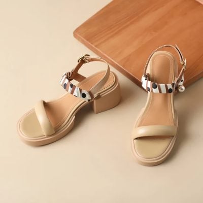 Comfortable beige summer sandals with ankle straps, decorative bow accents, and chunky heels, suitable for stylish daytime wear and casual outings.