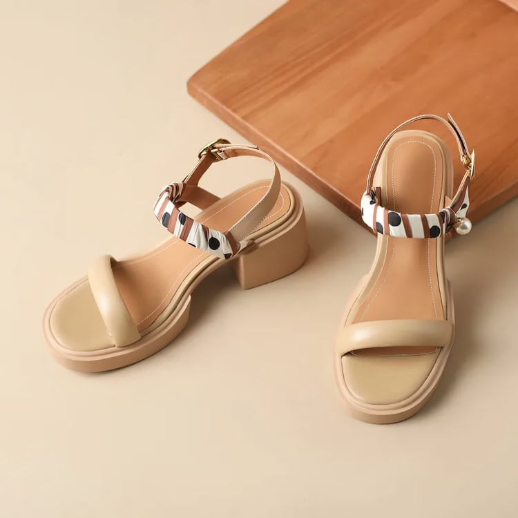 Comfortable beige summer sandals with ankle straps, decorative bow accents, and chunky heels, suitable for stylish daytime wear and casual outings.